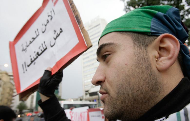 A man at a gay rights protest in Beirut holds a sign saying "The security forces should for our protection, not our torture." (Photo: Al-Akhbar)